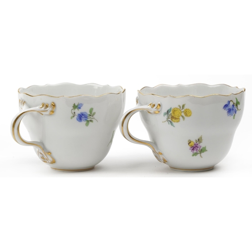 41 - Meissen, German porcelain hand painted with flowers comprising two cups with saucers and two plates,... 