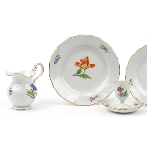 179 - Meissen, German porcelain hand painted with flowers comprising cup, two plates, milk jug and eggcup,... 