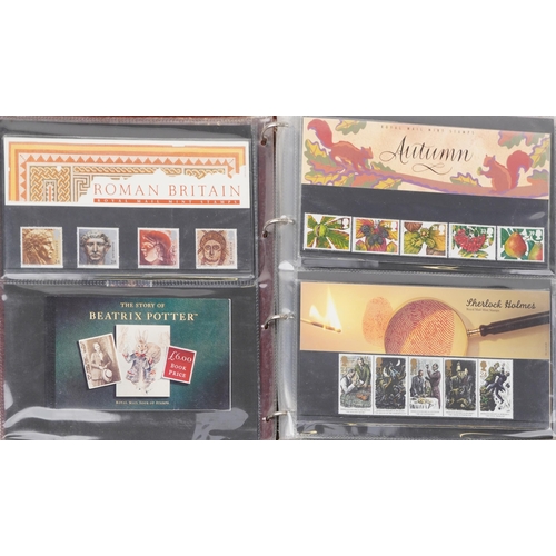 767 - Collection of Royal Mint presentation packs arranged in two albums, various genres and denominations