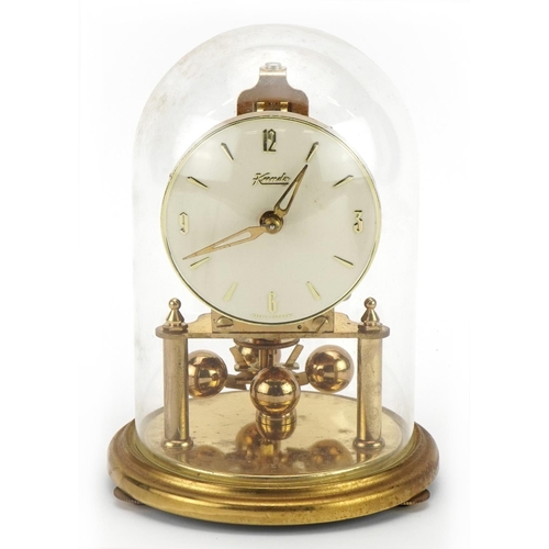 1323 - Kundo brass anniversary clock under a glass dome, 18cm high