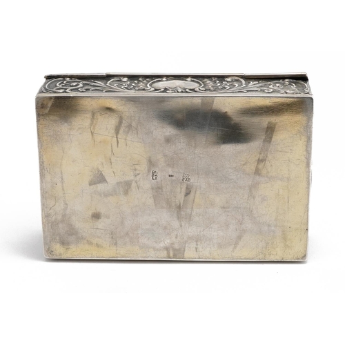 33 - Rectangular Dutch 930 grade silver casket with hinged lid embossed with figures and a dog amongst fl... 