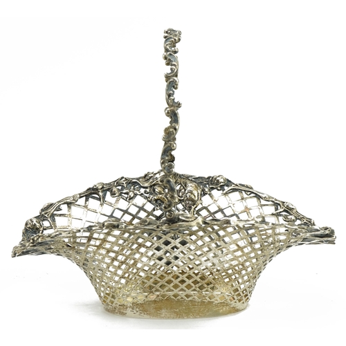 36 - The Metcalfe Company, sterling silver gilt pierced basket with swing handle embossed with flowers an... 