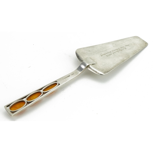 167 - German 830 grade silver wedding cake slice, the handle set with butterscotch amber cabochons, 22cm i... 