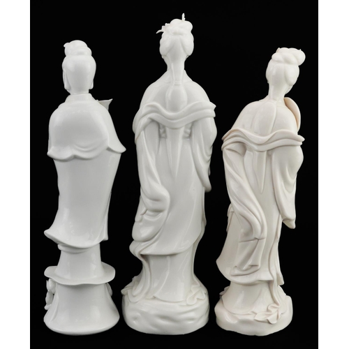 381 - Three Chinese porcelain figures of Guanyin, each having a blanc de chine glaze, the largest 27cm hig... 