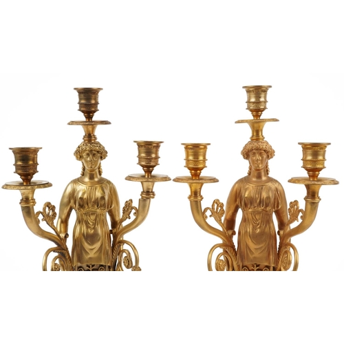 220 - Pair of French Empire style ormolu three branch figural candelabras raised on square marbleised base... 