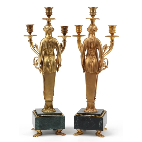 220 - Pair of French Empire style ormolu three branch figural candelabras raised on square marbleised base... 