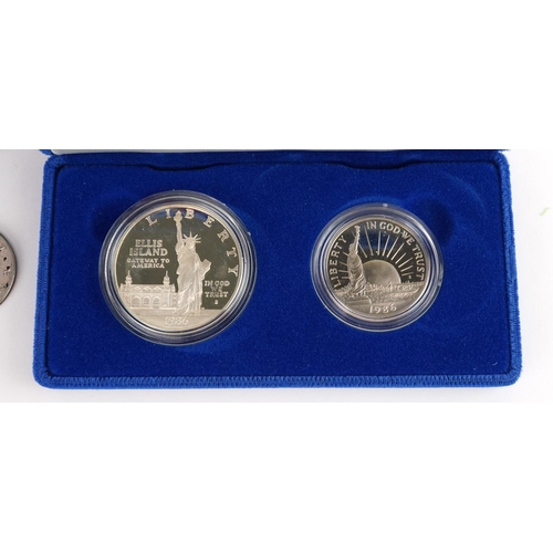 652 - United States of America silver proof 1986 Liberty dollar and half dollar with case and box and two ... 