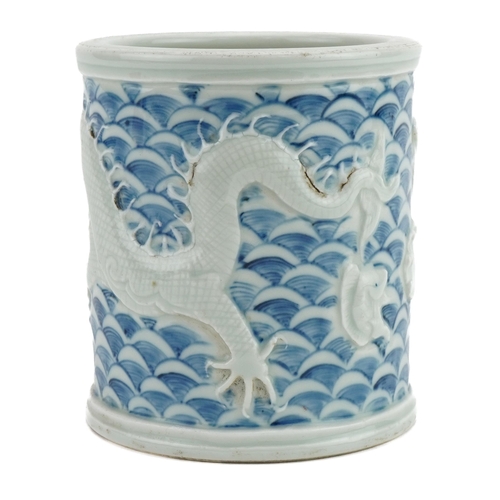 329 - Chinese blue and white porcelain brush pot decorated in relief with dragons, four figure character m... 