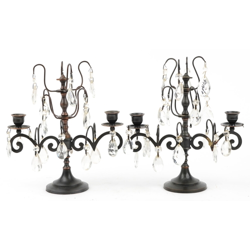 1498 - Pair of bronzed two branch lustre candelabrum with cut glass drops, 32cm high