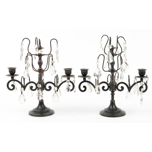 1498 - Pair of bronzed two branch lustre candelabrum with cut glass drops, 32cm high