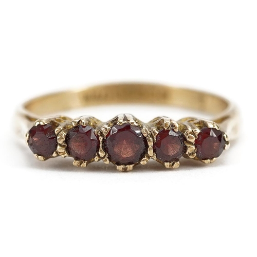 2138 - 9ct gold garnet five stone ring, the largest garnet approximately 3.2mm in diameter, size L/M, 1.9g