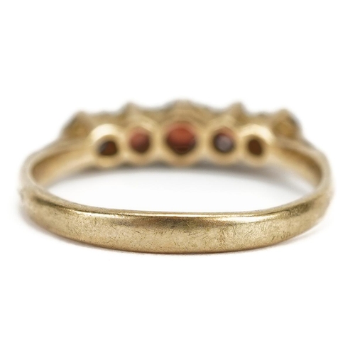 2138 - 9ct gold garnet five stone ring, the largest garnet approximately 3.2mm in diameter, size L/M, 1.9g