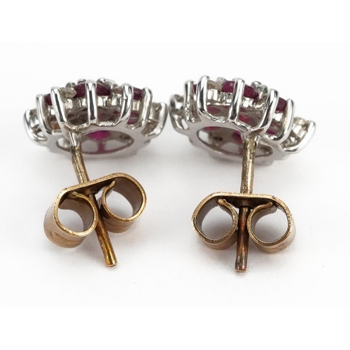 2042 - Pair of 9ct gold ruby and diamond cluster stud earrings, 1.0cm in diameter, 1.6g