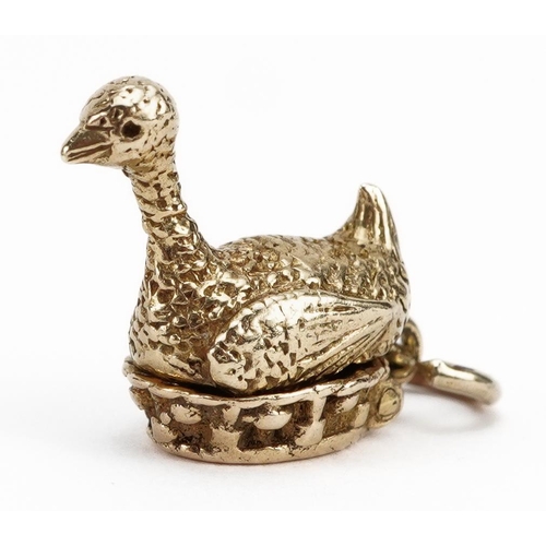 2137 - 9ct gold opening goose and golden egg charm, 1.5cm high, 3.6g