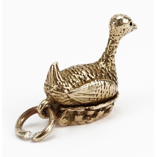 2137 - 9ct gold opening goose and golden egg charm, 1.5cm high, 3.6g