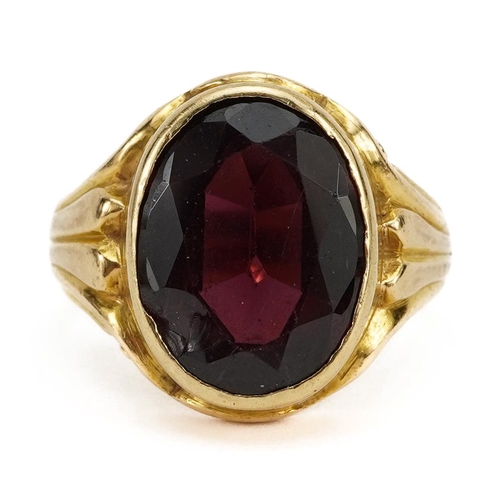 2052 - 18ct gold garnet solitaire ring with scrolled shoulders, the garnet approximately 12.9mm x 9.7mm, in... 