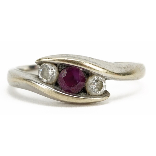 2069 - 9k white gold ruby and diamond three stone crossover ring, the ruby approximately 3.6mm in diameter,... 