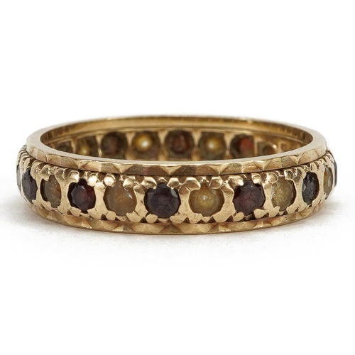2148 - 9ct gold garnet and clear stone eternity ring, size P, 2.9g