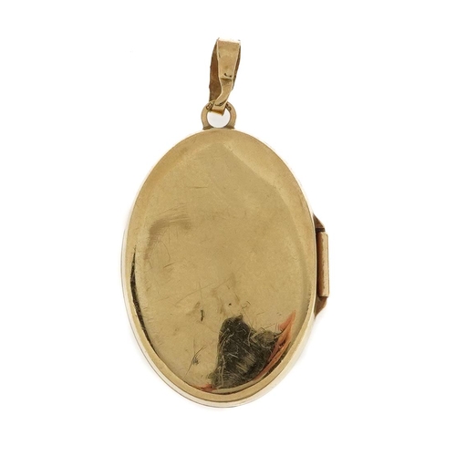 2154 - 9ct gold oval locket decorated with flowers, 3.4cm high, 3.1g