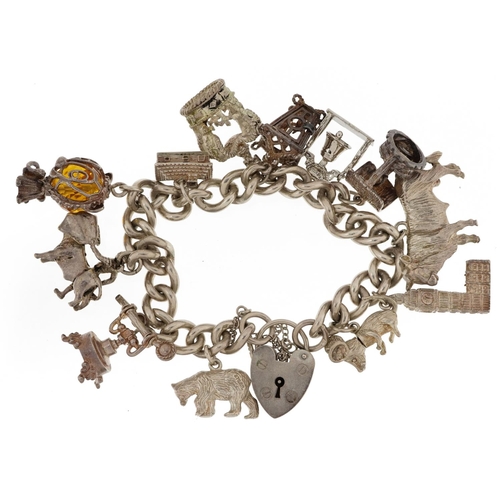 2097 - Silver charm bracelet with a selection of mostly silver charms including wishing well, Big Ben, pola... 