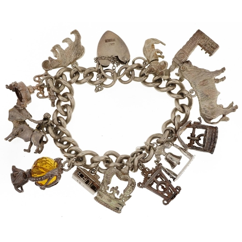 2097 - Silver charm bracelet with a selection of mostly silver charms including wishing well, Big Ben, pola... 