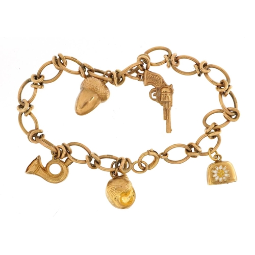 2051 - 9ct gold charm bracelet with a selection of 9ct gold and yellow metal charms including revolver, aco... 