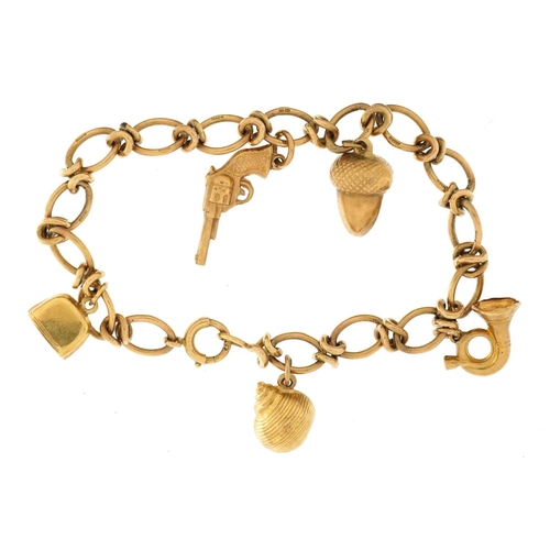 2051 - 9ct gold charm bracelet with a selection of 9ct gold and yellow metal charms including revolver, aco... 