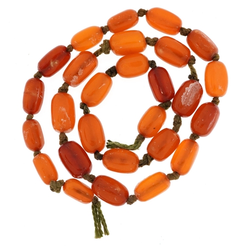 2124 - Butterscotch amber coloured bead necklace, the largest bead 1.6cm wide, 52cm in length, 25.6g