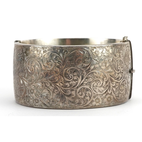 2108 - Vintage silver hinged bangle with engraved floral decoration, Birmingham 1937, 6.3cm wide, 49.2g