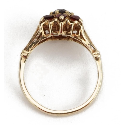 2125 - 9ct gold garnet flower head ring, the largest garnet approximately 4.6mm in diameter, size Q, 3.8g