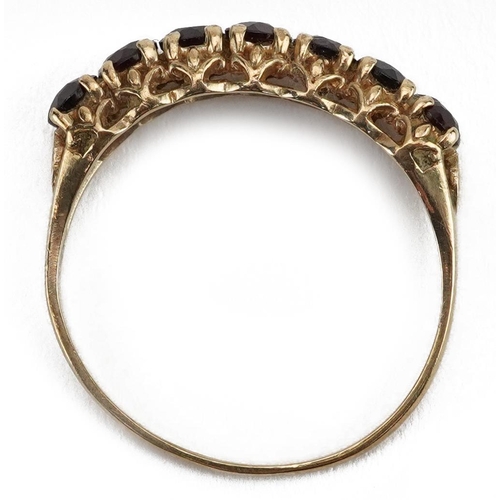 2155 - 9ct gold garnet seven stone ring, size P, 1.6g