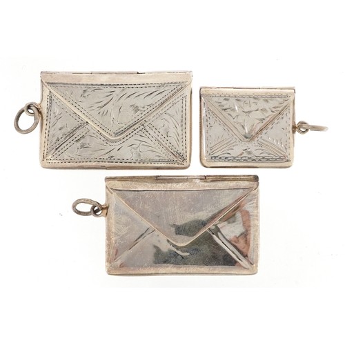 170 - Three silver stamp cases in the form of envelopes, two with engraved decoration, one with London imp... 