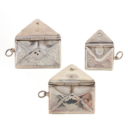 170 - Three silver stamp cases in the form of envelopes, two with engraved decoration, one with London imp... 