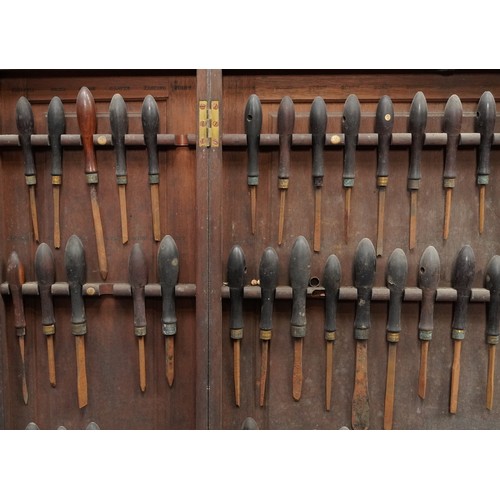 341 - Collection of predominantly rosewood handled woodworking chisels arranged in a mahogany wall hanging... 