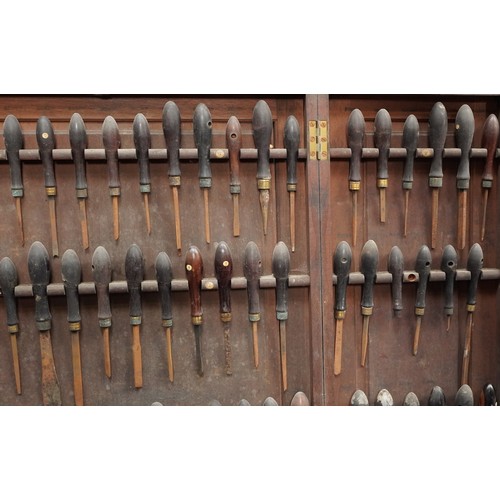 341 - Collection of predominantly rosewood handled woodworking chisels arranged in a mahogany wall hanging... 