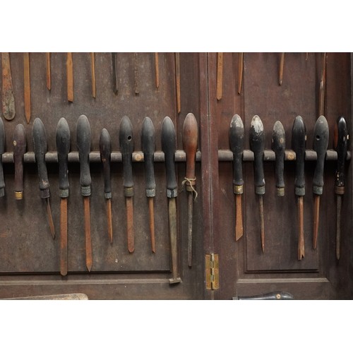 341 - Collection of predominantly rosewood handled woodworking chisels arranged in a mahogany wall hanging... 