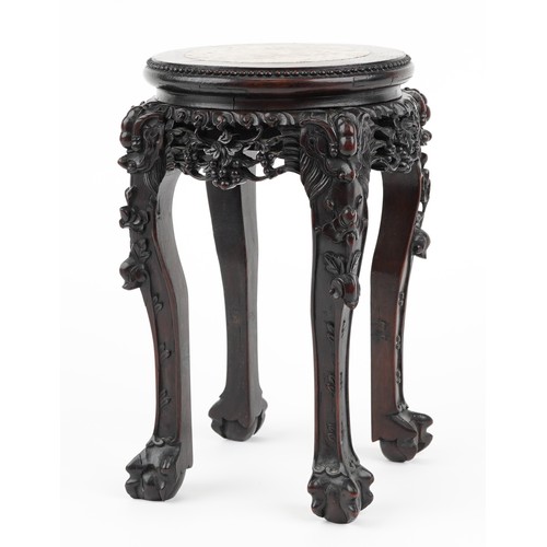 268 - Chinese hardwood vase stand with inset marble top finely carved with mythical faces and foliage, pos... 