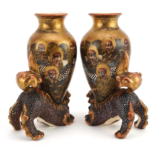 103 - Pair of Japanese Satsuma pottery vases surmounted on Foo dogs and a dish, each hand painted with imm... 