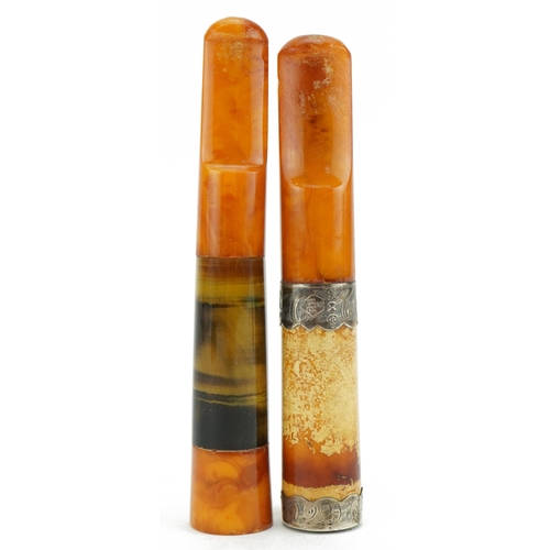 240 - Two large late 19th/early 20th century butterscotch amber cigarette holders comprising one with tige... 