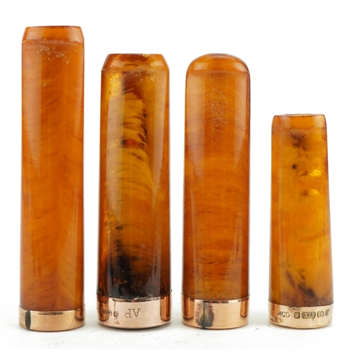 121 - Four late 19th/early 20th century butterscotch amber cigarette holders with 9ct gold mounts, each ho... 