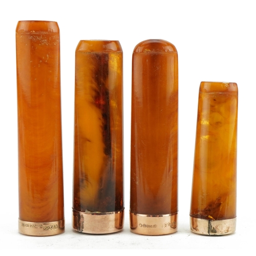 121 - Four late 19th/early 20th century butterscotch amber cigarette holders with 9ct gold mounts, each ho... 