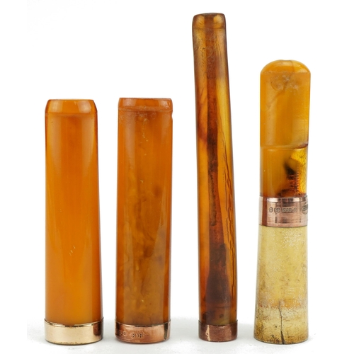 122 - Four late 19th/early 20th century amber and amber coloured cigarette holders with 9ct gold and 18ct ... 