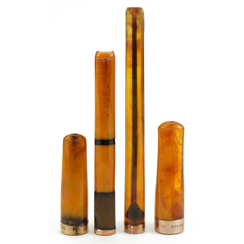 79 - Four late 19th/early 20th century butterscotch amber and amber coloured cigarette holders with 9ct g... 