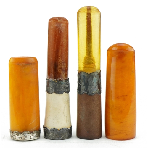 118 - Four late 19th/early 20th century cigarette holders including two butterscotch amber examples, three... 