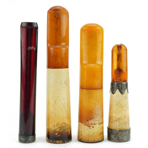 119 - Four late 19th/early 20th century cigarette holders including butterscotch amber and cherry amber co... 