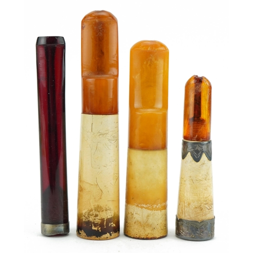 119 - Four late 19th/early 20th century cigarette holders including butterscotch amber and cherry amber co... 