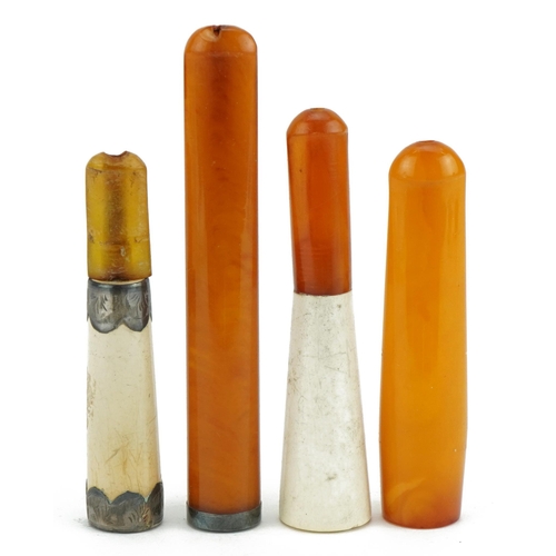 120 - Four late 19th/early 20th century cigarette holders including two butterscotch amber examples and tw... 