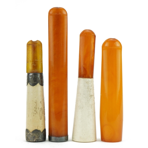 120 - Four late 19th/early 20th century cigarette holders including two butterscotch amber examples and tw... 