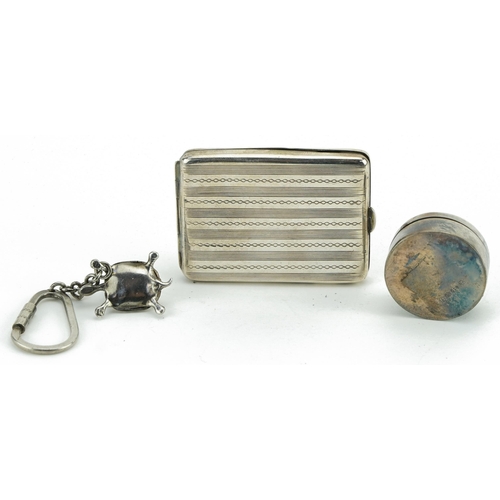 423 - Silver objects comprising rectangular match case, circular pillbox with hinged lid and a tortoise ke... 