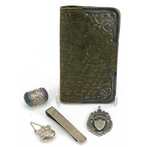 425 - Edwardian and later silver objects including a silver mounted leather purse, sport's jewel, money cl... 